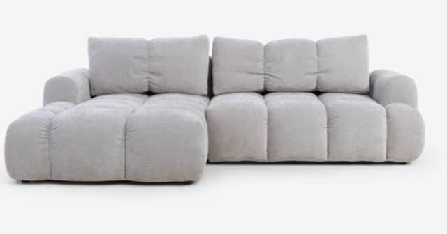A modern modular sectional sofa upholstered in light grey fabric, featuring deep, plush, segmented c… — 3D model