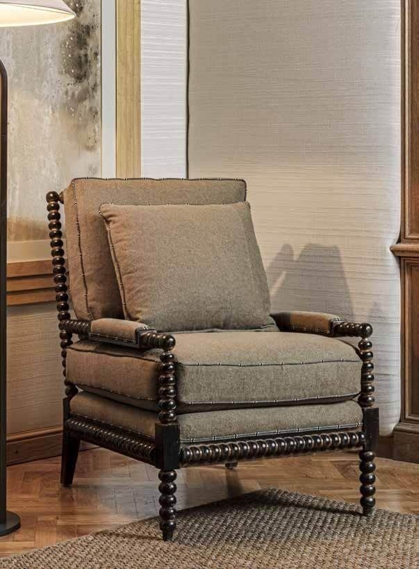 A dark-stained wooden armchair with a distinctive bobbin-turned frame and light brown upholstered cu… — 3D model