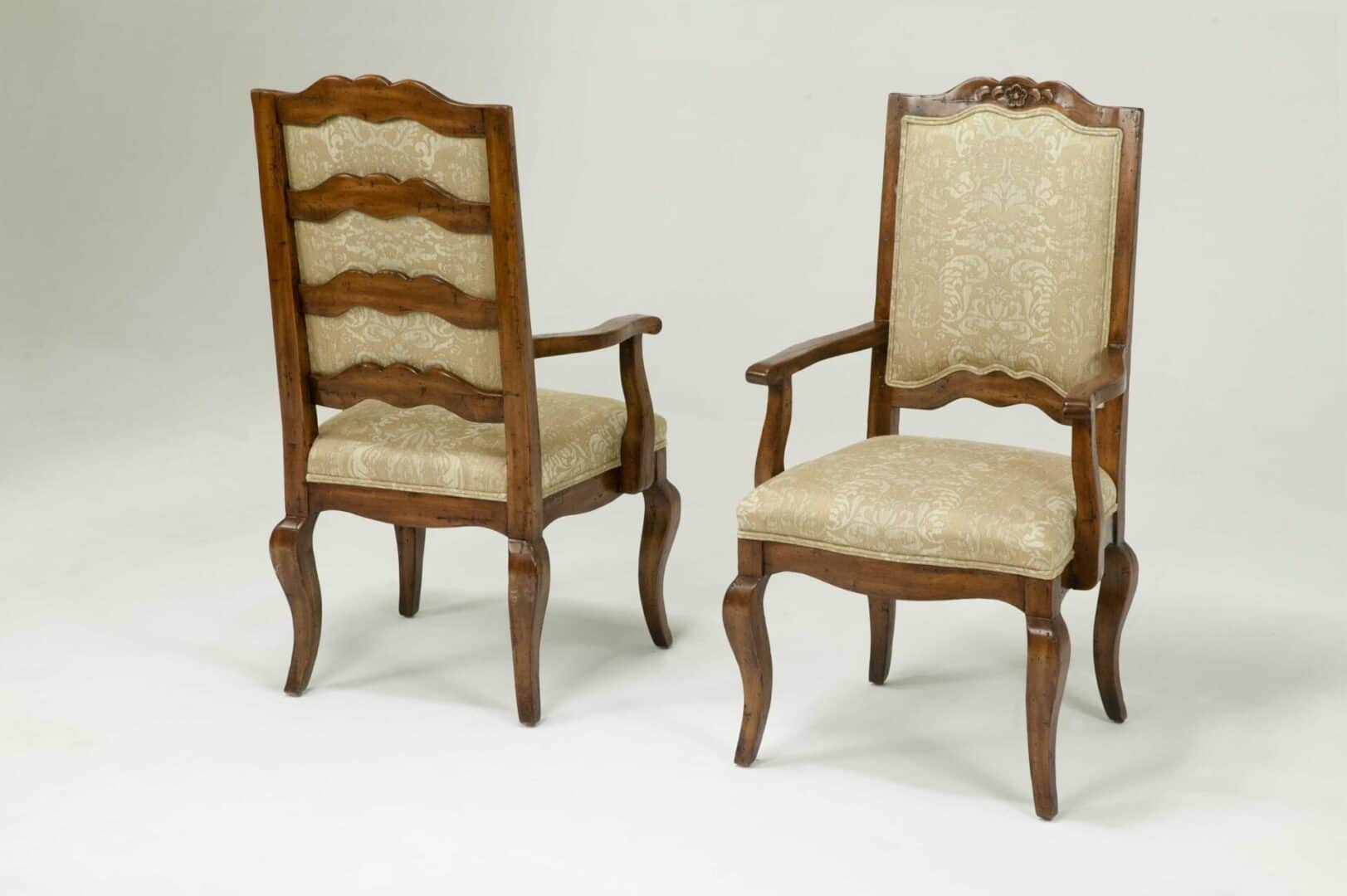 A traditional armchair featuring a dark, carved wooden frame and upholstered seat and backrest in a… — free OBJ 3D model