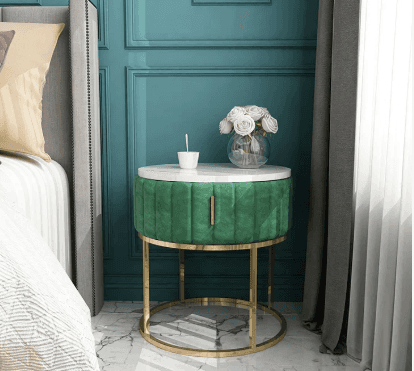 A round side table featuring a white marble top, a channel-tufted emerald green velvet body with a p… — 3D model