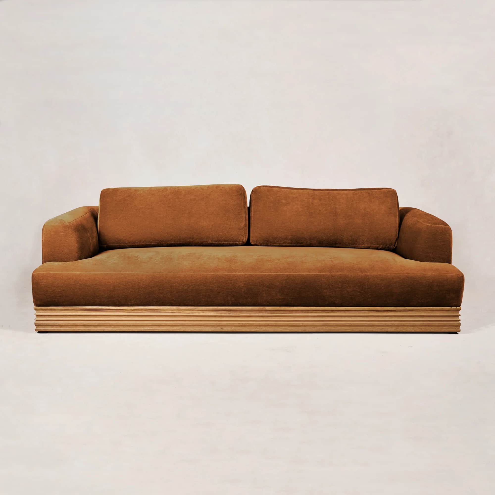 A modern three-seater sofa with plush, tufted cushions and a low profile. The sofa features a distin… — free GLTF 3D model
