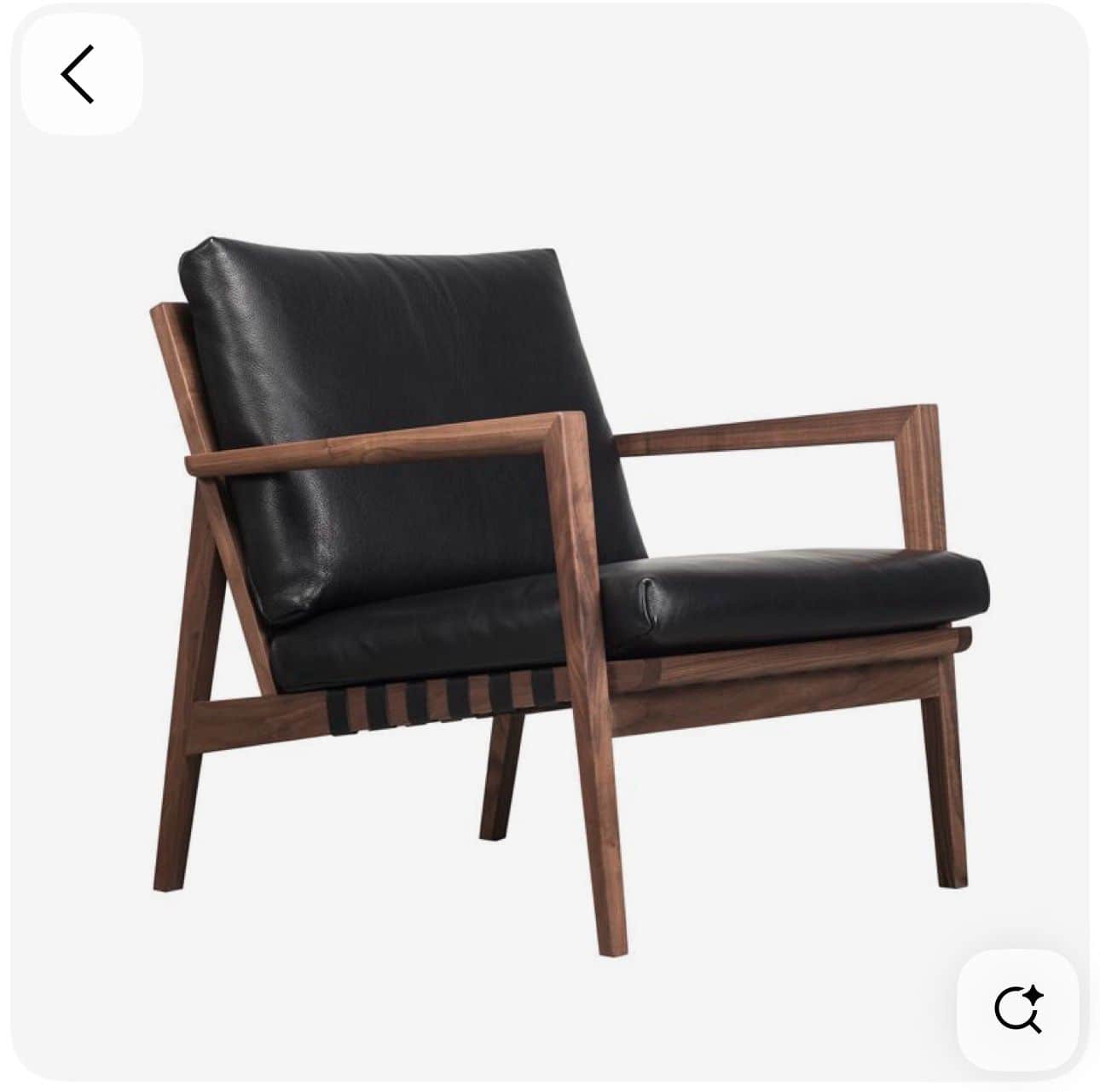 A stylish armchair featuring an exposed dark wood frame, likely walnut, and plush black leather seat… — 3D model