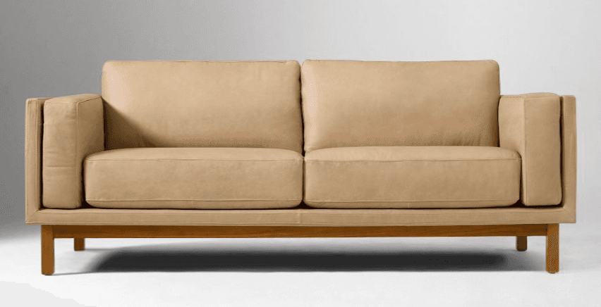 A modern two-seater sofa upholstered in light tan leather, featuring an exposed light wooden frame a… — 3D model