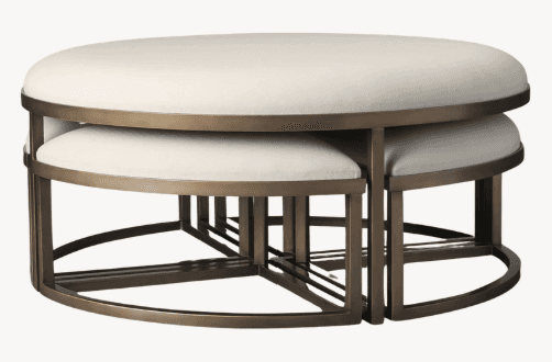A set of nesting ottomans with oval upholstered tops and a metal frame. The larger ottoman is positi… — 3D model