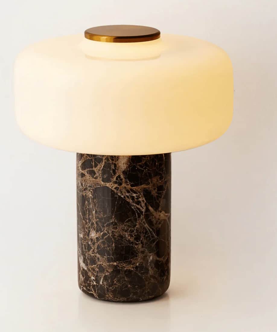 A contemporary table lamp featuring a cylindrical base made of dark brown marble, topped with a broa… — 3D model