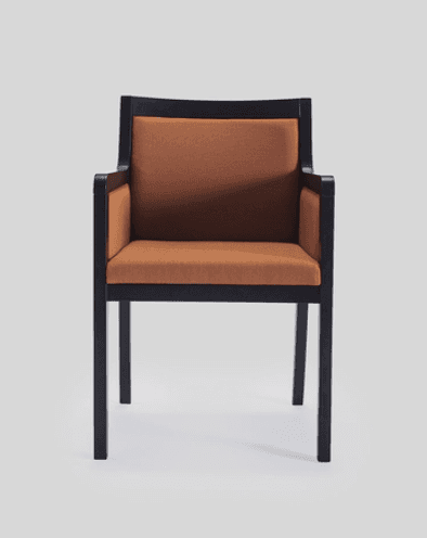 An armchair with a dark frame and upholstered seat and back in a rust-colored fabric. The frame has… — 3D model