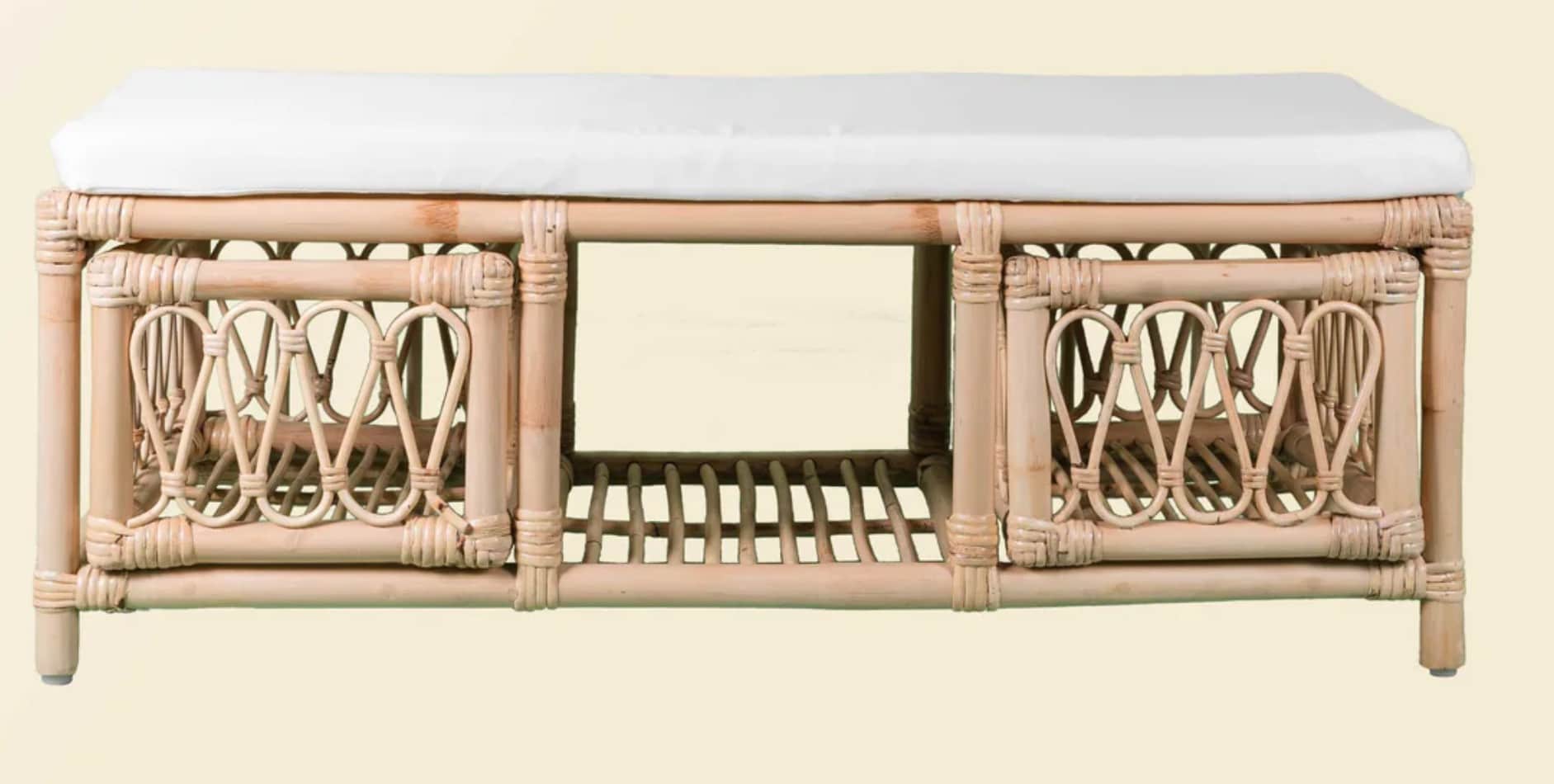 A long, rectangular bench featuring a natural rattan and bamboo frame, topped with a white fabric cu… — 3D model