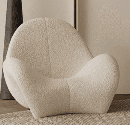 A contemporary lounge chair with a fluid, sculptural form, fully upholstered in an off-white bouclé… — free SKP 3D model