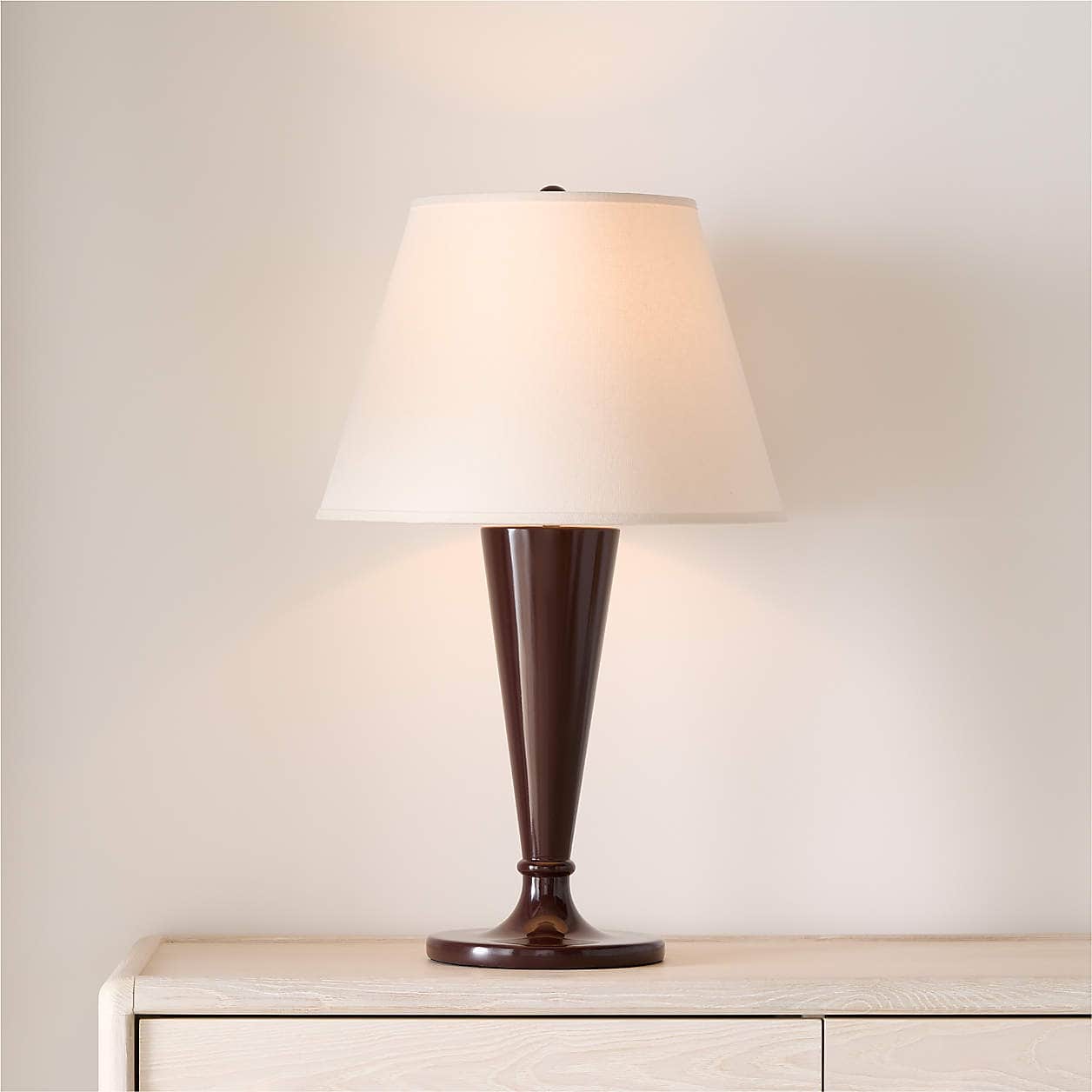 A table lamp featuring a dark brown, possibly lacquered, tapered base resting on a circular foot, to… — free GLTF 3D model