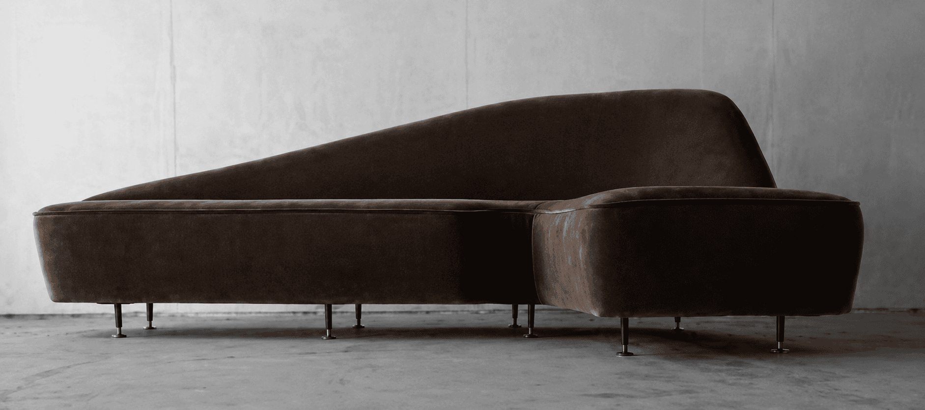 An L-shaped modular sectional sofa featuring a distinctively curved backrest on one side and an inte… — free STL 3D model
