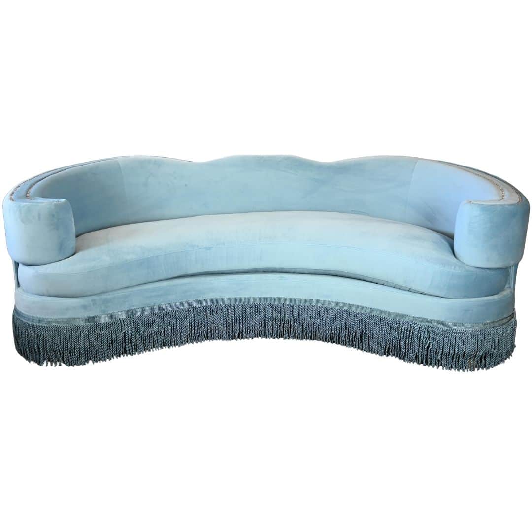 A vintage, pale blue sofa with a curved, serpentine back and rolled arms. It features a detailed fri… — 3D model