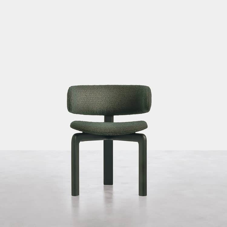 A modern armless chair featuring a low, plush, dark green bouclé-textured upholstered backrest and s… — 3D model