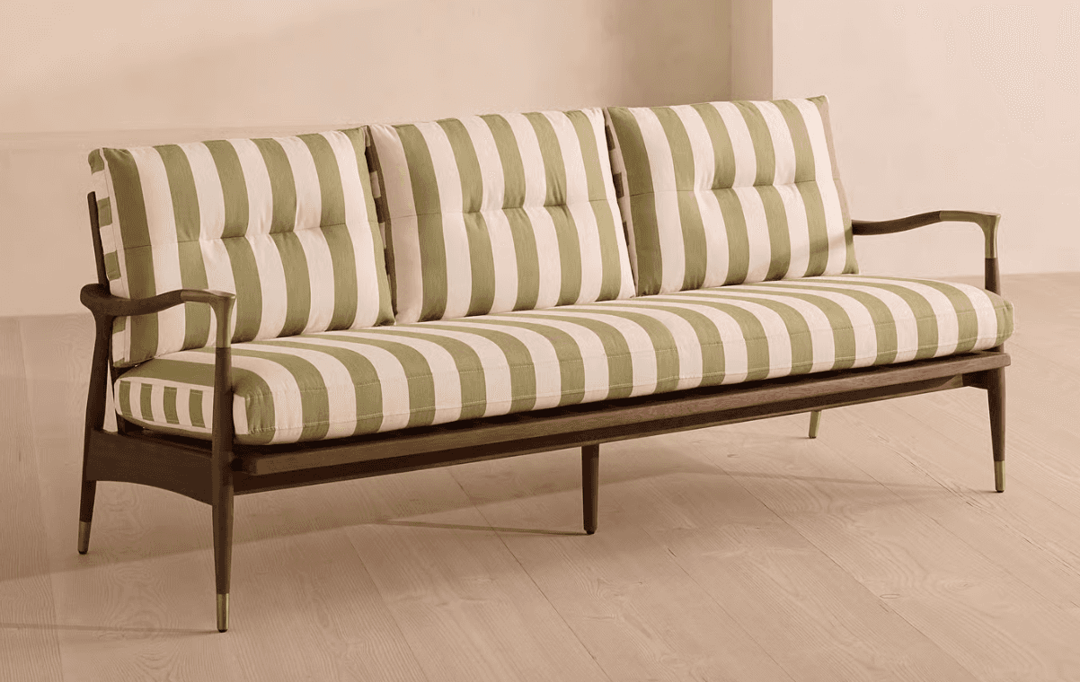 A contemporary three-seater sofa featuring a distinctive exposed dark wood frame, light olive green… — 3D model