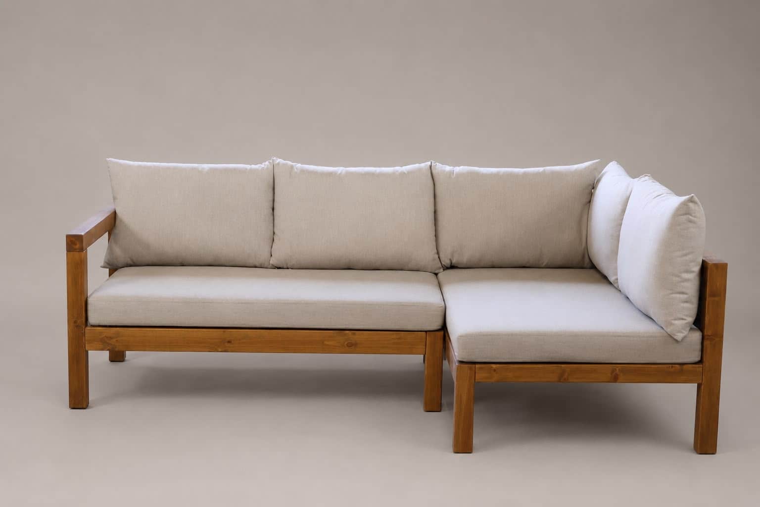 An L-shaped sectional sofa featuring a prominent light-toned wooden frame and light beige fabric cus… — 3D model