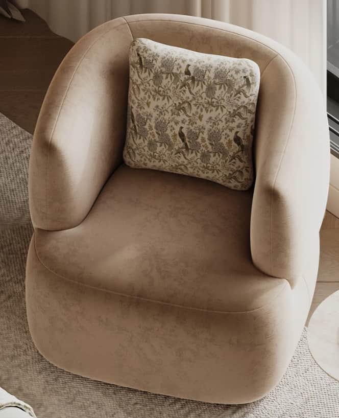 A contemporary upholstered accent chair featuring a rounded, enveloping silhouette with integrated a… — 3D model