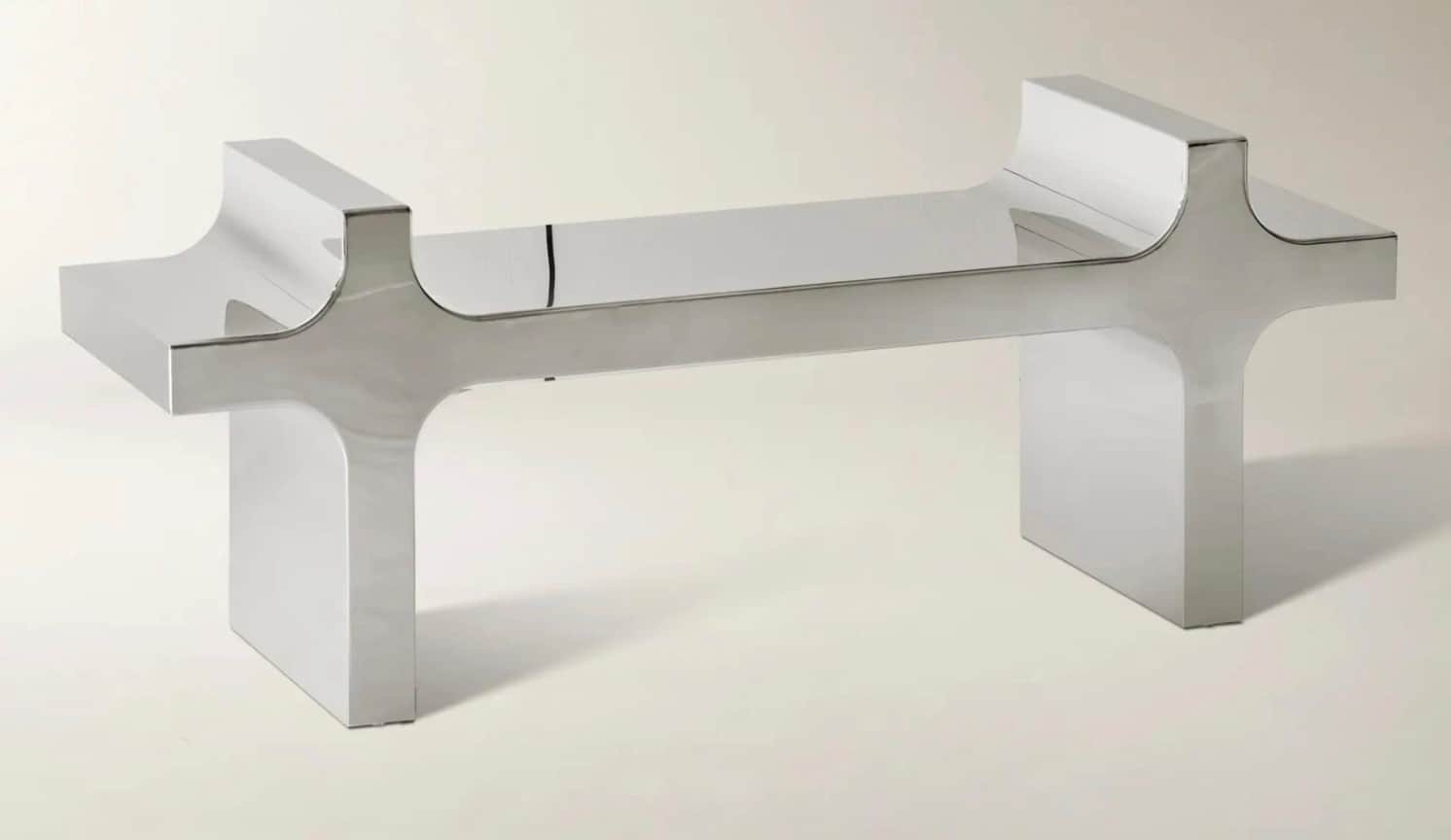 A modern coffee table with a striking silhouette. It features two substantial, geometric legs with c… — 3D model