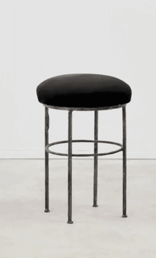 A black bar stool with a round, upholstered seat and a base constructed from four slender, dark meta… — free SKP 3D model