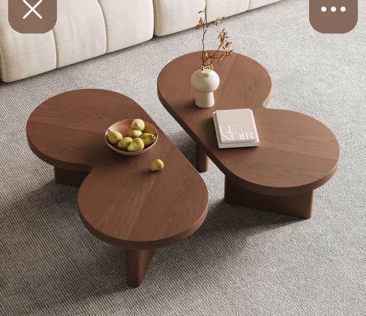 A modern coffee table with an organic, asymmetrical top and a minimalist base. The tabletop features… — 3D model