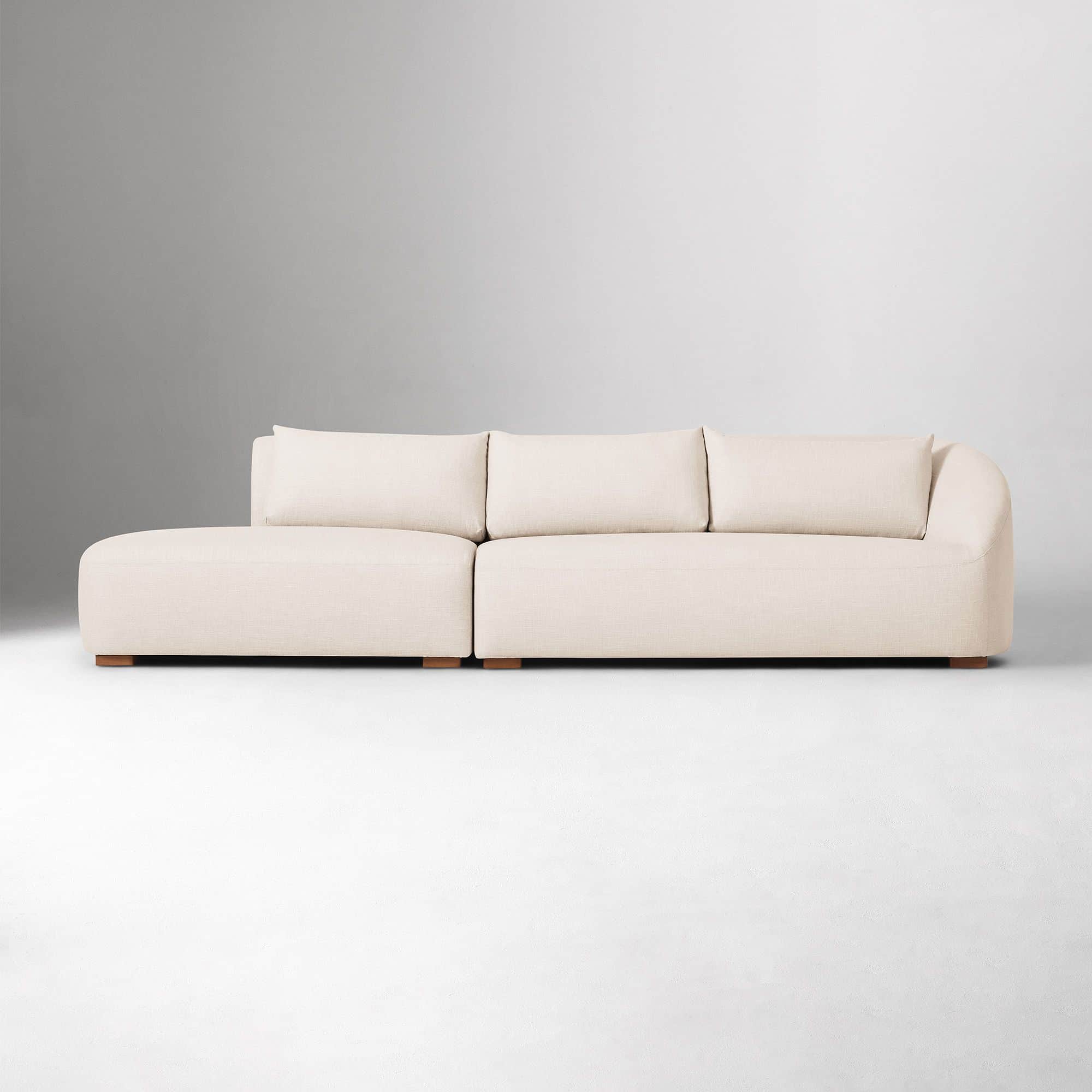 A sectional sofa with a chaise lounge. The sofa has a low profile and is upholstered in a textured f… — 3D model