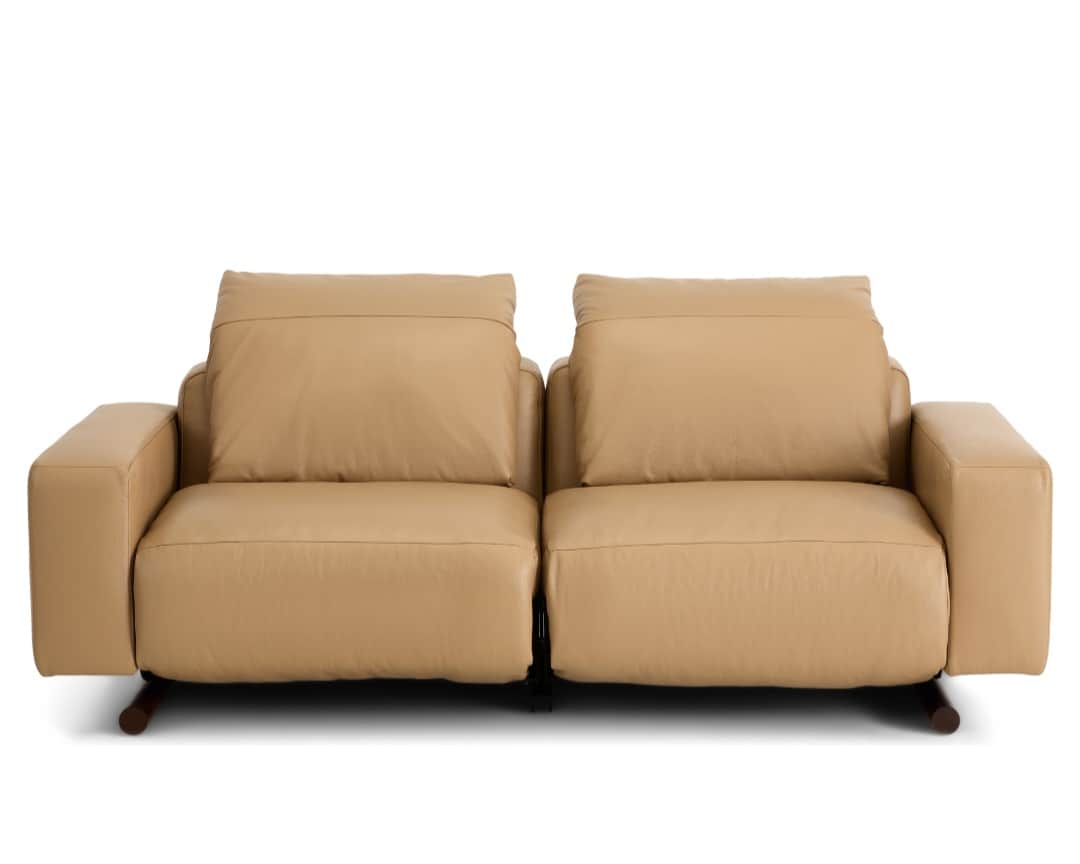 A modern two-seater reclining sofa, upholstered in smooth, light tan leather. It features two indivi… — 3D model