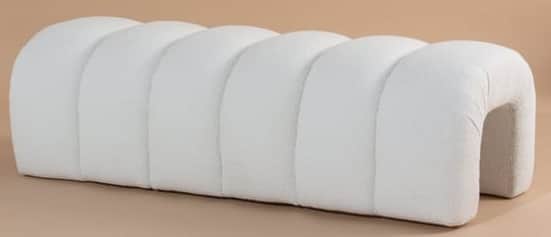 A contemporary upholstered bench featuring a distinctive segmented design, with multiple rounded, tu… — 3D model