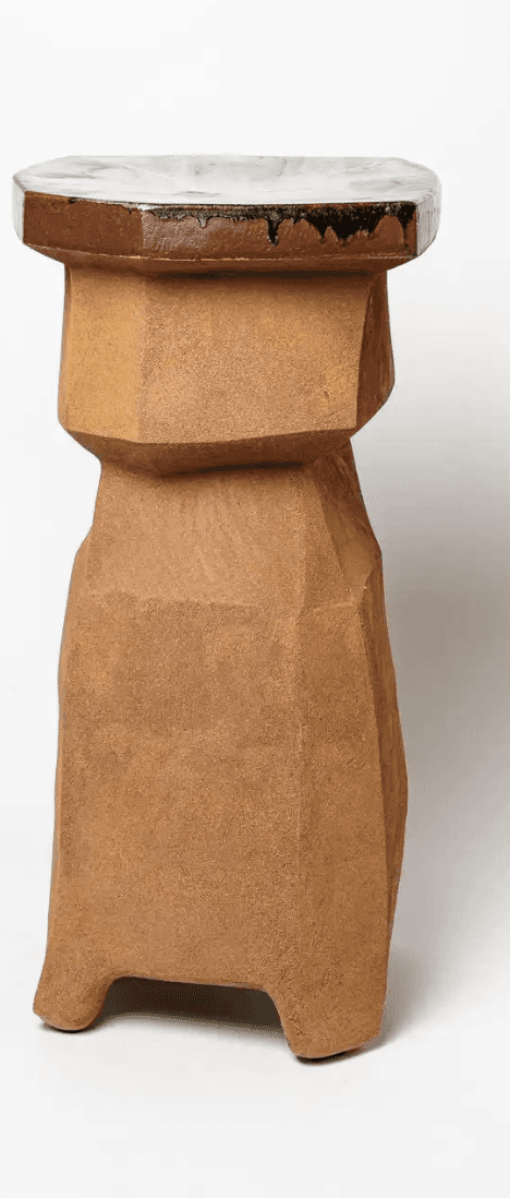 An octagonal pedestal table featuring a faceted, unglazed ceramic body in an earthy brown tone, topp… — 3D model