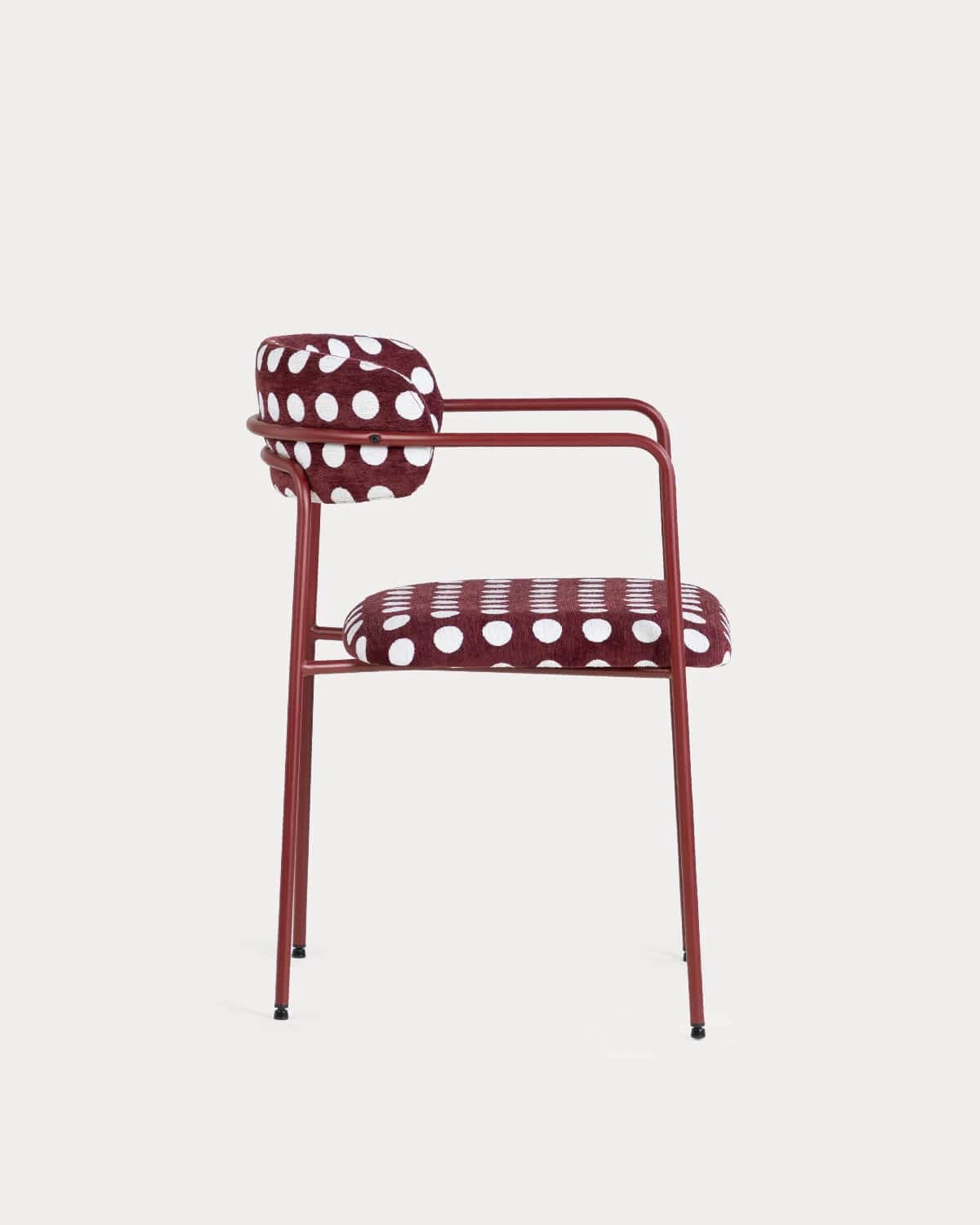 A contemporary armchair featuring a tubular metal frame finished in a matte red or burgundy hue. The… — free OBJ 3D model
