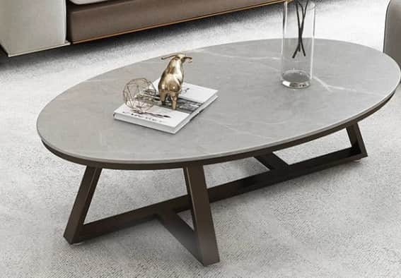 An oval coffee table featuring a light grey top with subtle white veining, resembling marble, suppor… — 3D model