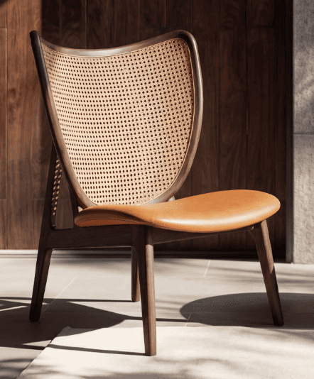 A contemporary lounge chair featuring a dark stained wooden frame, a gently curved backrest with wov… — free FBX 3D model