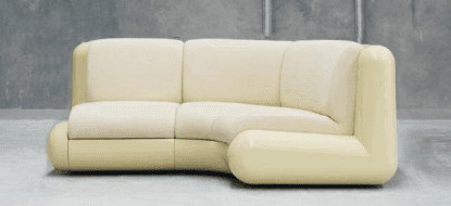 A cream-colored sectional sofa with a curved design. The sofa features multiple seating cushions and… — free GLTF 3D model