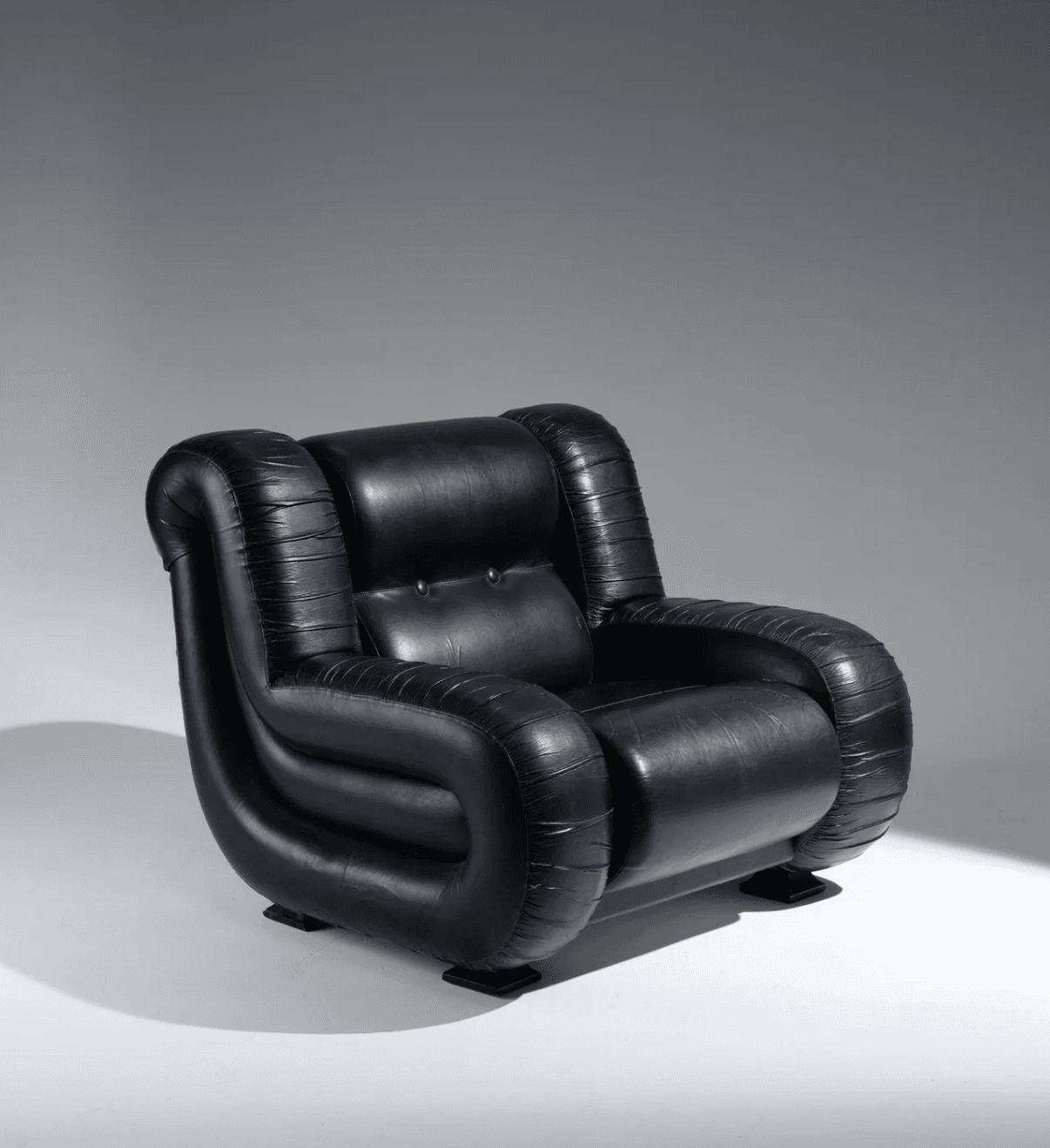 A black leather armchair with a distinctive, puffy, curvilinear design. The armchair features rounde… — 3D model