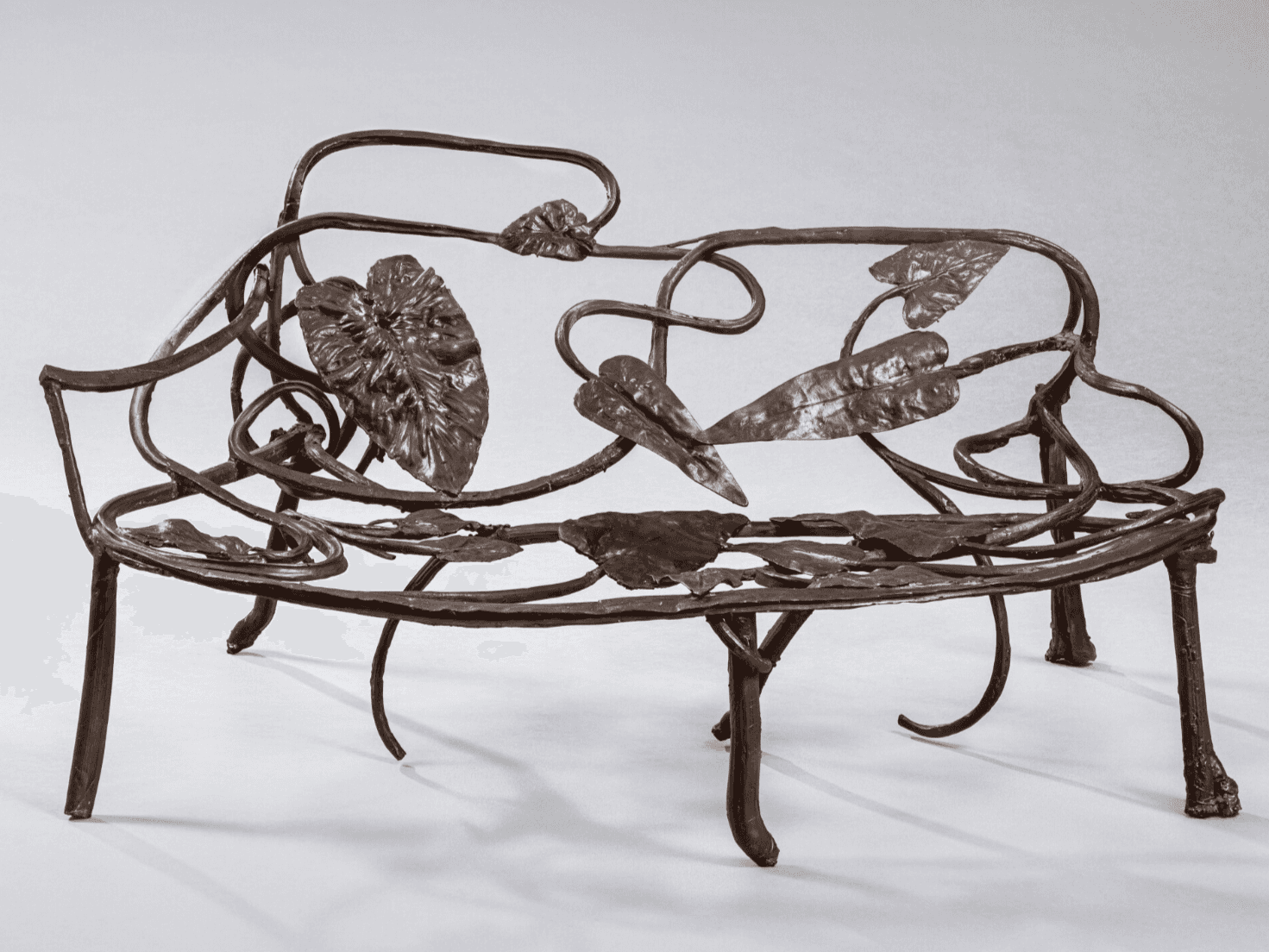 An ornate metal bench featuring a design inspired by nature, with curved metalwork resembling vines… — free STL 3D model