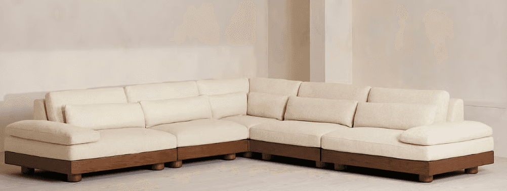 An L-shaped modular sectional sofa featuring light-colored fabric upholstery with distinctive vertic… — 3D model