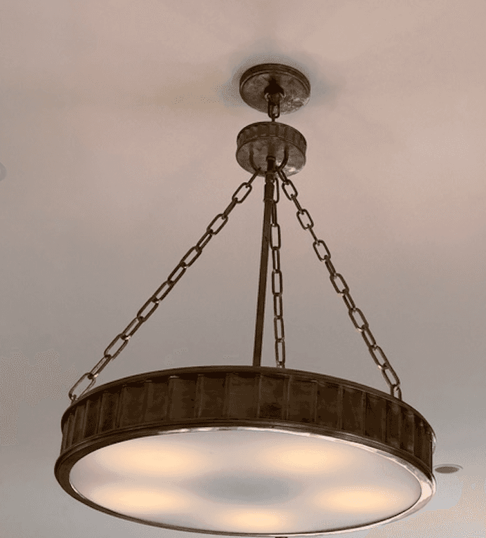 A rustic-style chandelier featuring a drum-shaped shade with a ribbed metal band around its circumfe… — 3D model