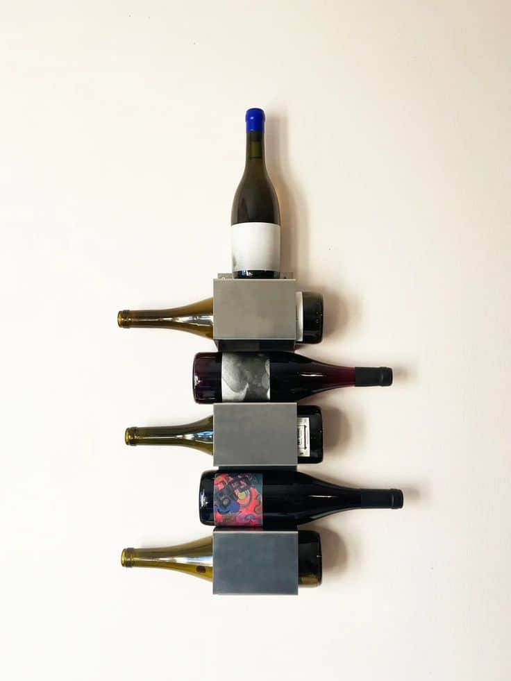 A minimalist wall-mounted wine rack made of brushed metal, designed to store multiple wine bottles h… — 3D model