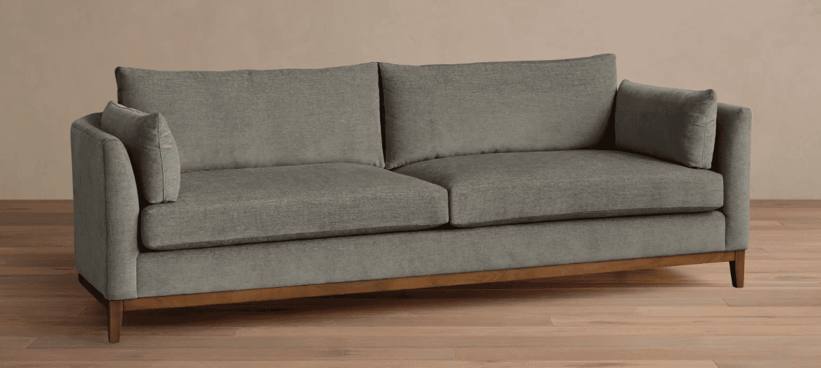 A contemporary two-seater sofa featuring gray fabric upholstery, loose seat and back cushions, and a… — 3D model
