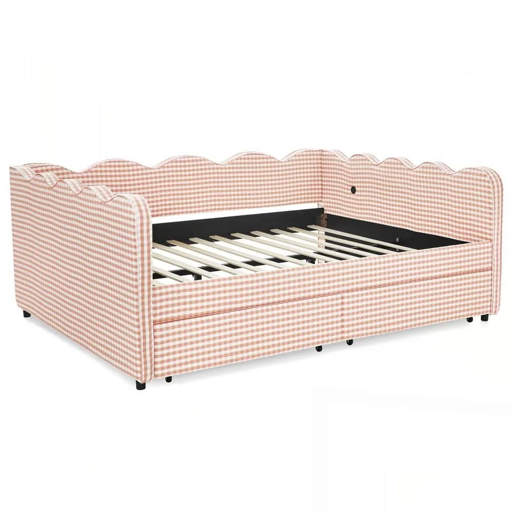 A daybed upholstered in a pink and white gingham fabric with a scalloped headboard and side rails. T… — 3D model