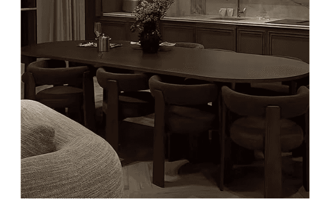 A modern dining set consisting of an oval table and six matching chairs, all in a dark brown finish.… — 3D model