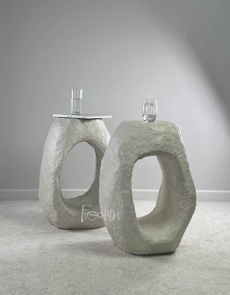 A stool with an abstract, sculptural form. It features a solid, roughly shaped body with a large, ir… — free SKP 3D model