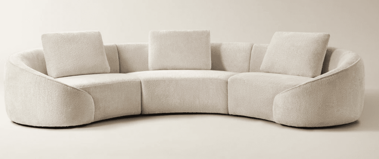 A large, contemporary curved sectional sofa upholstered in a light, textured bouclé fabric, featurin… — 3D model