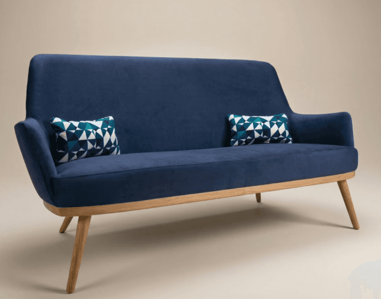A two-seater sofa with blue upholstery and a visible wooden frame and legs. The design features a ge… — free GLTF 3D model