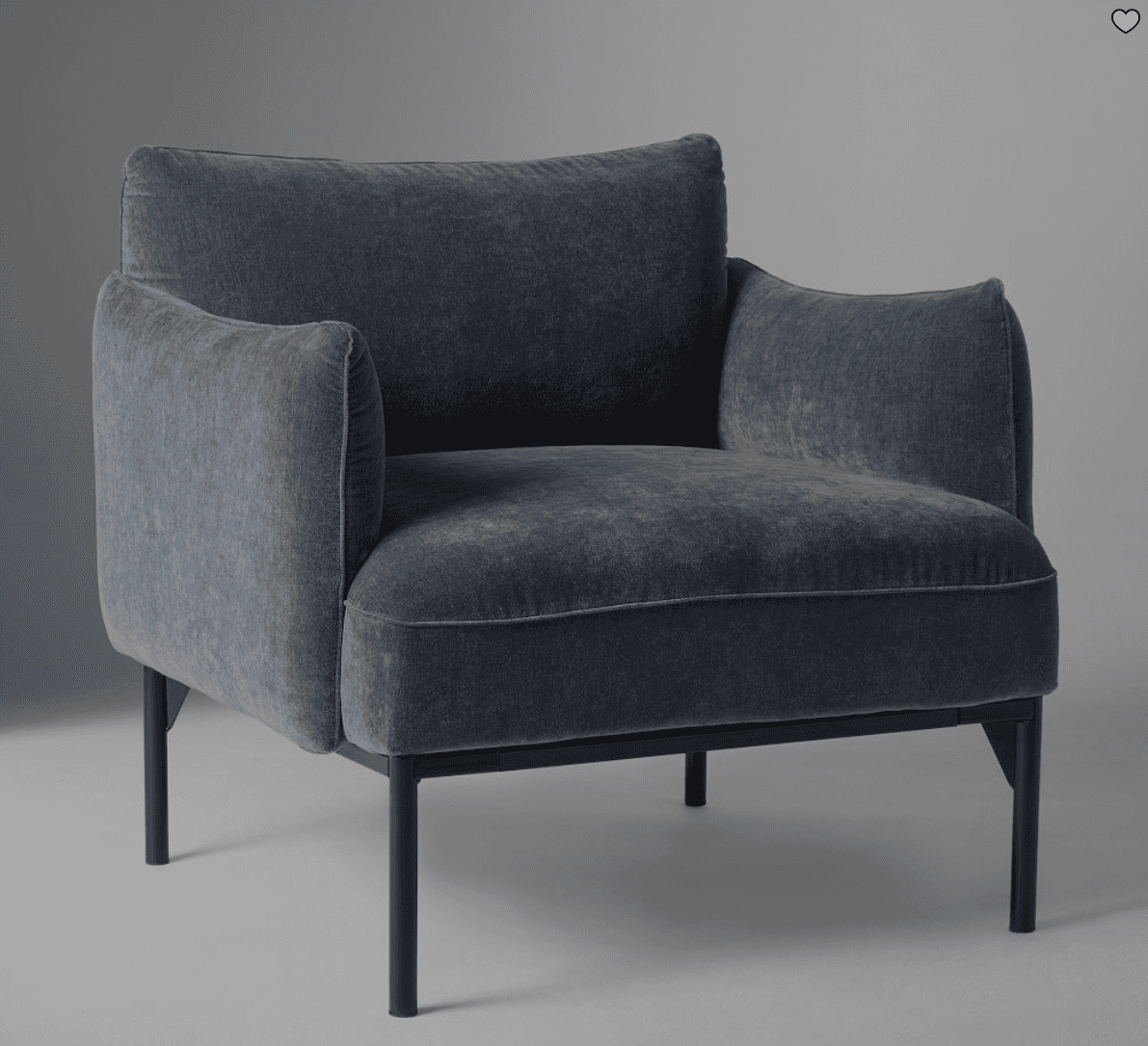 A modern armchair with a plush, upholstered seat, back, and arms, supported by a slender, dark metal… — free OBJ 3D model