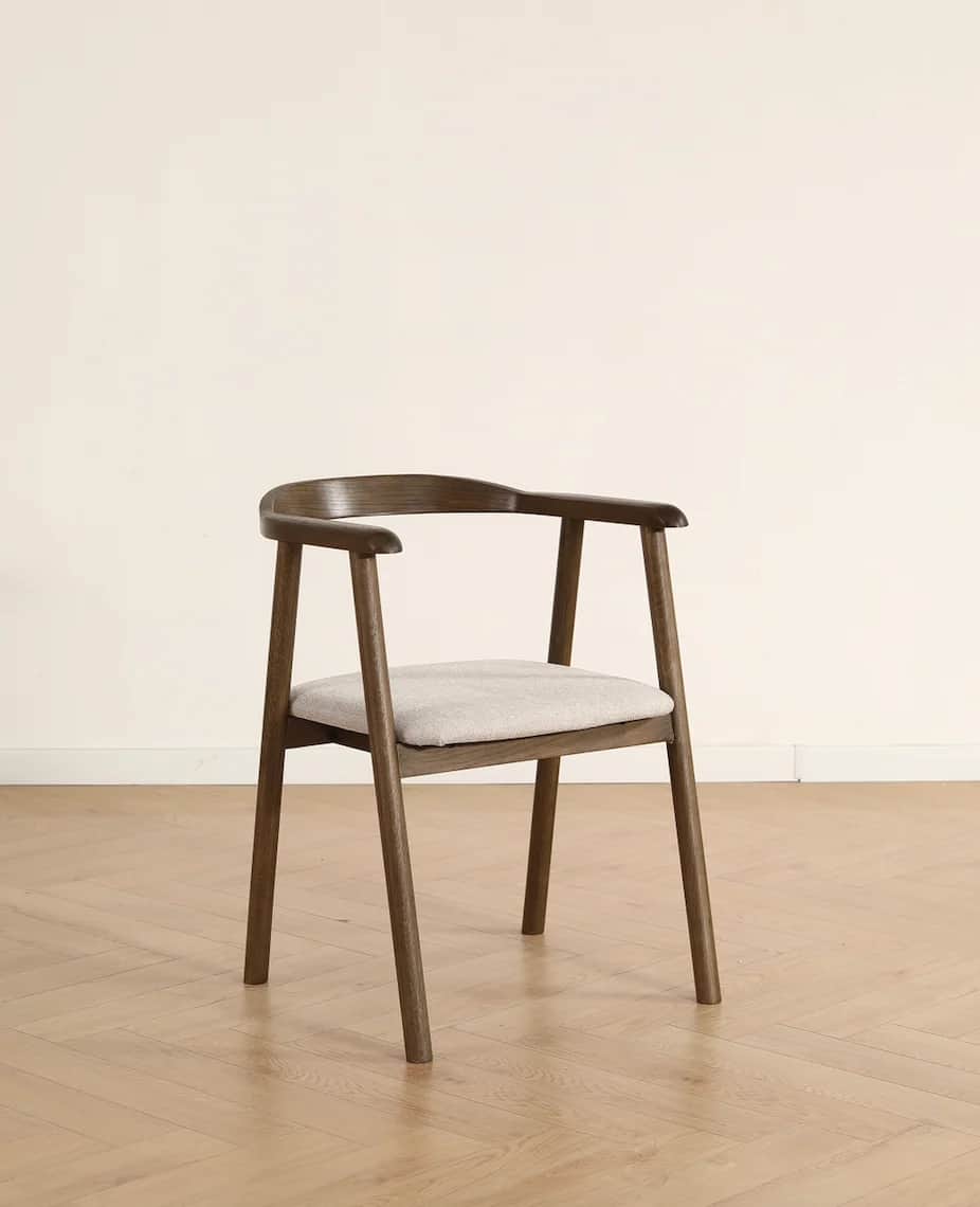 A modern dining armchair crafted from dark wood with a curved backrest and integrated armrests, feat… — 3D model