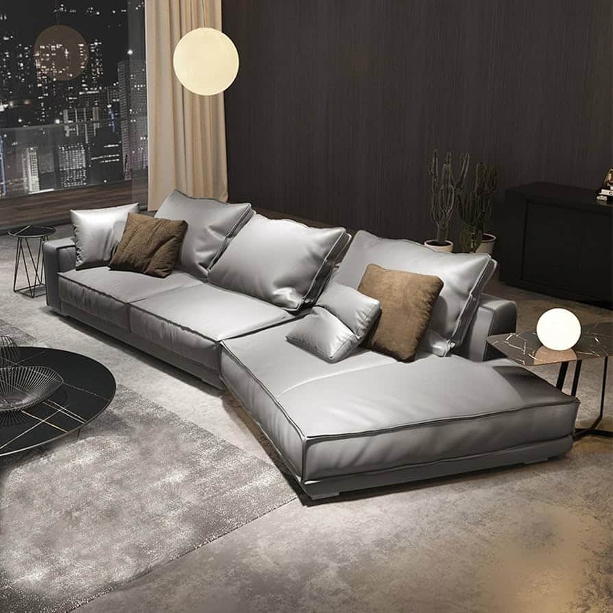 A modern L-shaped sectional sofa upholstered in a light grey leather or high-quality faux leather, f… — free SKP 3D model