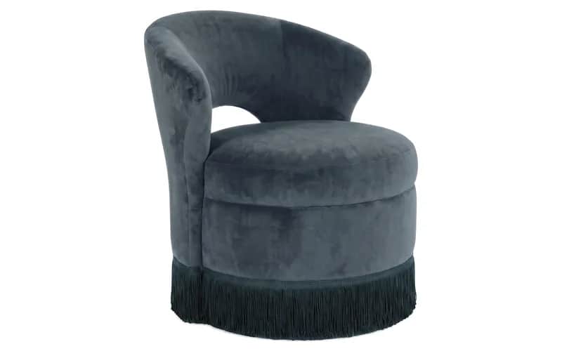 A compact, barrel-shaped accent chair upholstered in dark grey velvet, featuring a continuous curved… — 3D model