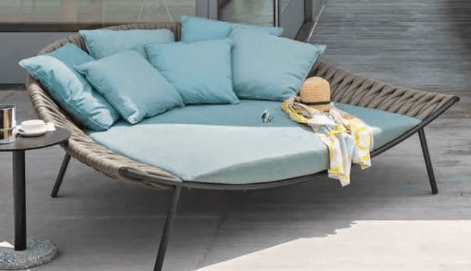 A modern outdoor daybed featuring a semi-circular form with a tightly woven gray synthetic rope back… — 3D model
