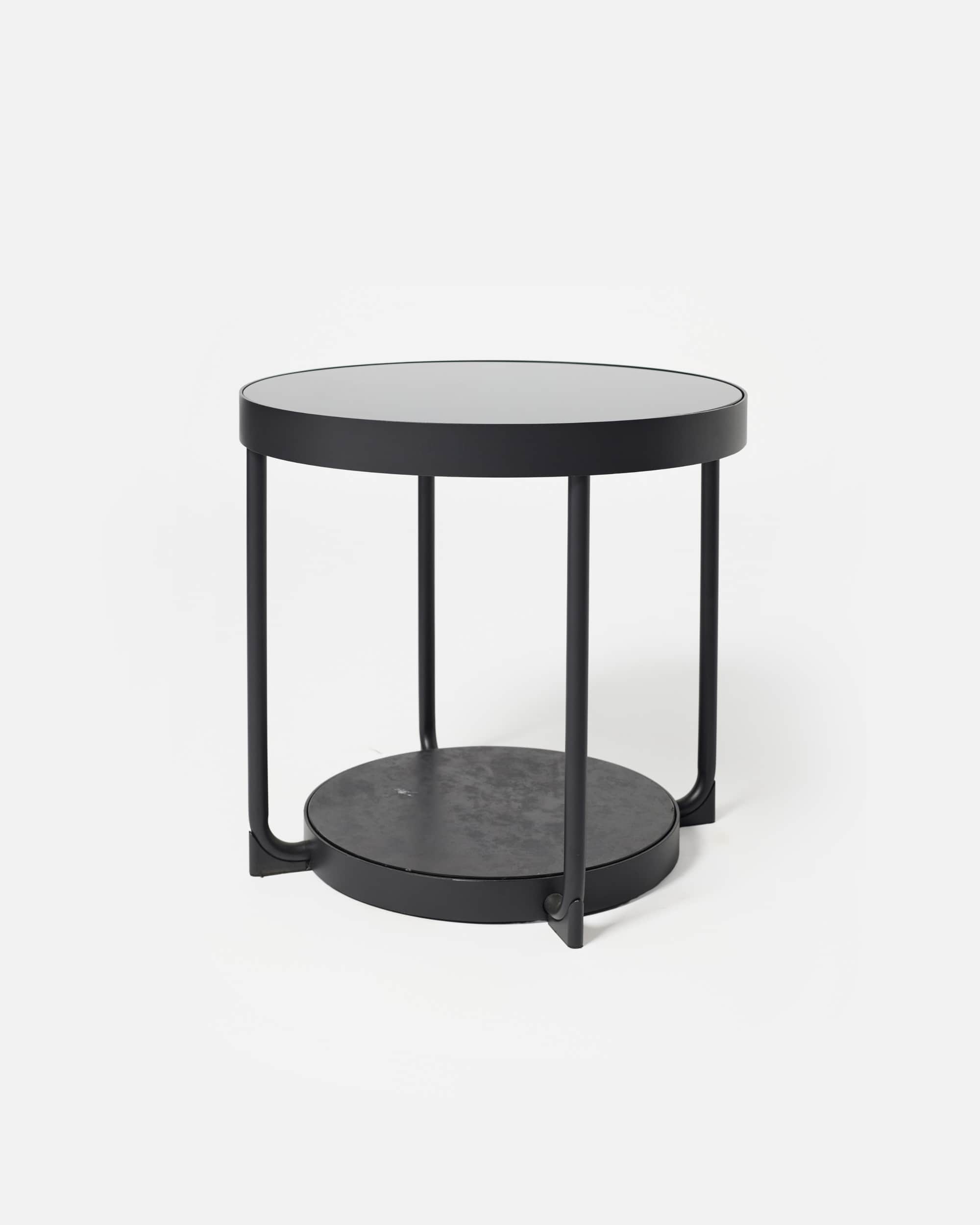A modern, minimalist round side table featuring two circular tiers. The table is constructed from bl… — 3D model