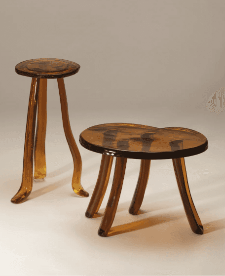 A compact, three-legged stool featuring a round, slightly dished seat and three organically curved l… — 3D model