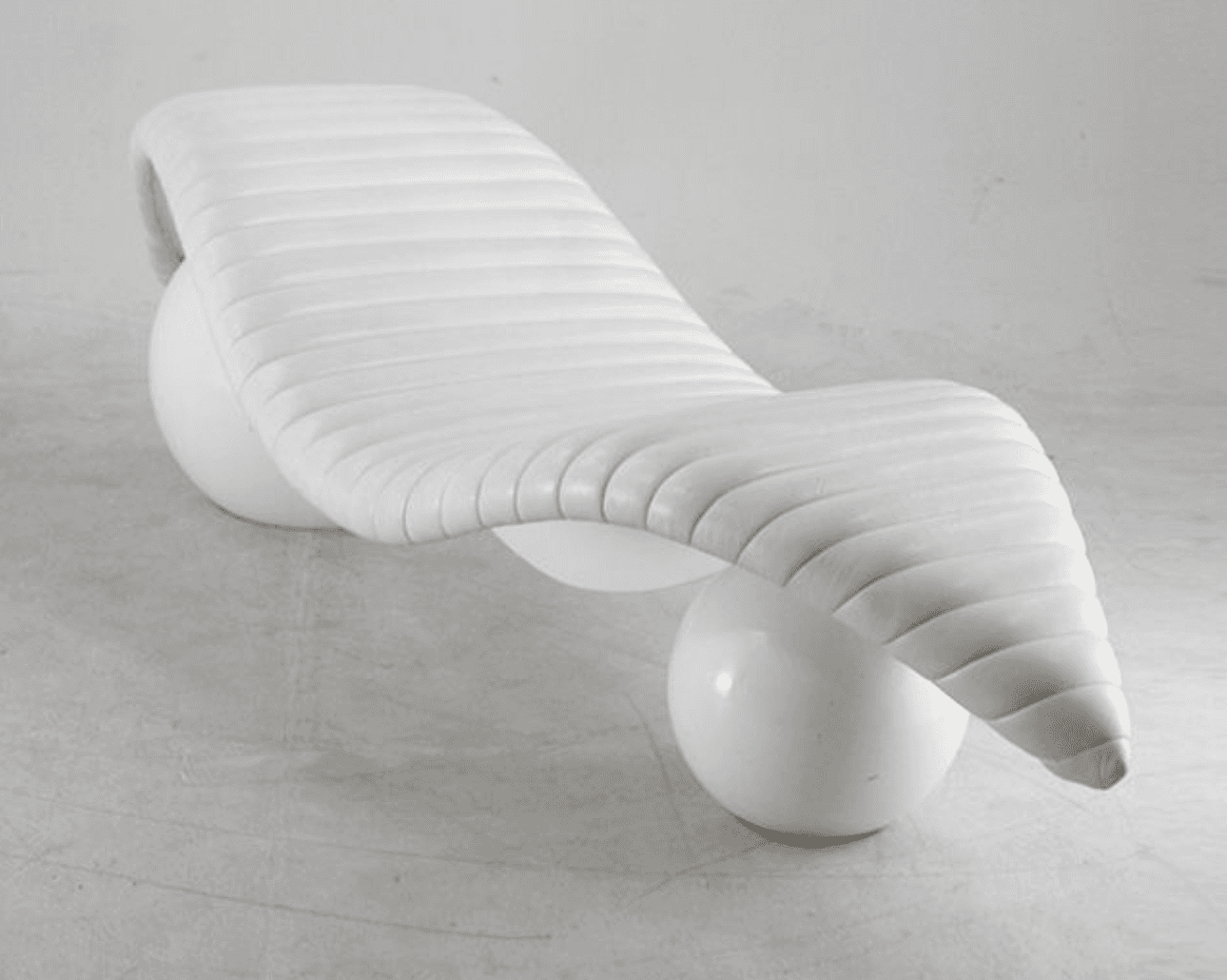 A contemporary white chaise lounge with a distinctive sculptural design. The seating surface is elon… — 3D model