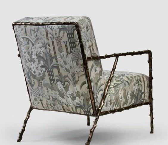 A single armchair with a distinctive frame structure resembling bamboo stalks and a patterned fabric… — free BLEND 3D model